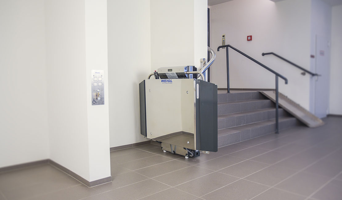 Eingeklappter Plattformtreppenlift STRATOS im Innenbereich